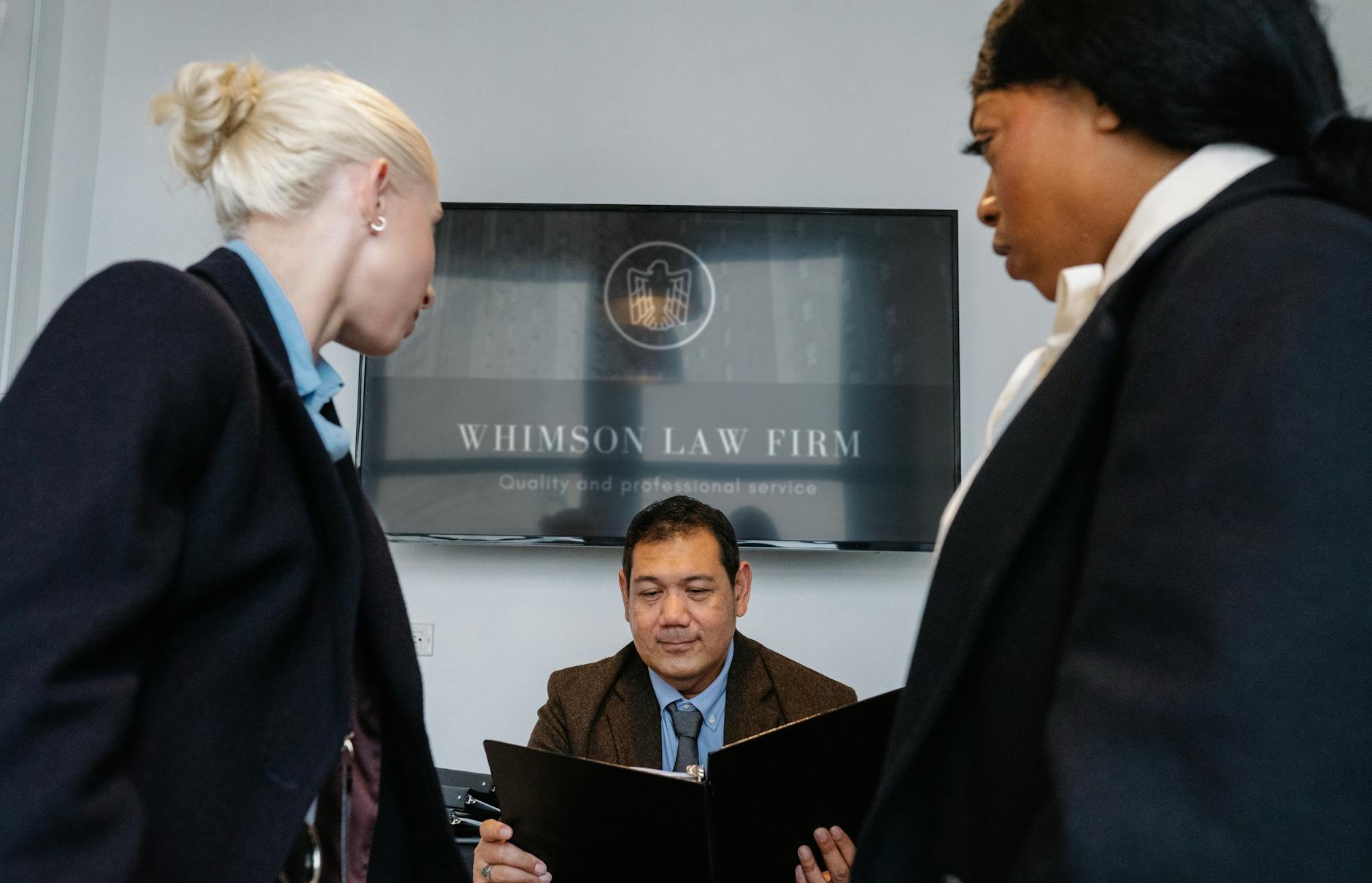 A diverse team of Legal Advisory Group attorneys collaborating around a conference table in a modern law office